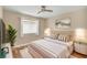 Serene bedroom featuring a comfortable bed, soft lighting, and a view of the outdoors at 1227 Tuscany Blvd, Venice, FL 34292
