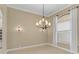 Dining room with ample natural light, neutral color scheme, and elegant chandelier at 1227 Tuscany Blvd, Venice, FL 34292