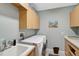 Laundry room featuring a utility sink, washer, dryer and upper storage cabinets at 1227 Tuscany Blvd, Venice, FL 34292