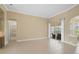 Spacious living room featuring tile floors and sliding glass doors leading to the outside patio at 1227 Tuscany Blvd, Venice, FL 34292