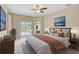 Beautifully decorated main bedroom with pool access, soft lighting, and elegant furnishings at 1227 Tuscany Blvd, Venice, FL 34292