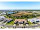 Home features tile roof, paver driveway and pristine landscaping, with community views at 14369 Eagle Branch Dr, Nokomis, FL 34275