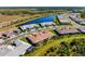 Aerial view of home with a tile roof, manicured lawn, and beautiful lake view at 14369 Eagle Branch Dr, Nokomis, FL 34275