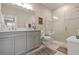 Bright bathroom features double vanity, framed mirror, and glass enclosed shower with decorative tile and seating at 14369 Eagle Branch Dr, Nokomis, FL 34275
