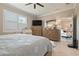 Bright bedroom with ceiling fan, dressers, and doorway to another room at 14369 Eagle Branch Dr, Nokomis, FL 34275