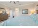 Inviting bedroom features a ceiling fan, dresser, and doorway at 14369 Eagle Branch Dr, Nokomis, FL 34275