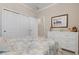 Comfortable bedroom features a decorative painting, dresser, and large closet at 14369 Eagle Branch Dr, Nokomis, FL 34275