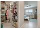 Spacious walk-in closet with custom shelves and drawers adjacent to the primary bedroom at 14369 Eagle Branch Dr, Nokomis, FL 34275