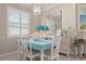 Dining area with elegant light fixture and view of shuttered windows at 14369 Eagle Branch Dr, Nokomis, FL 34275