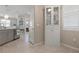 Bright kitchen area with white china cabinet and doorway leading to living spaces at 14369 Eagle Branch Dr, Nokomis, FL 34275