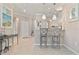 Kitchen pass-through features bar stool seating and access to the entryway at 14369 Eagle Branch Dr, Nokomis, FL 34275