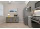 Bright kitchen includes stainless steel appliances, grey cabinets, and breakfast nook at 14369 Eagle Branch Dr, Nokomis, FL 34275