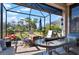 Spacious screened lanai with outdoor seating areas and views of the landscaped backyard at 14369 Eagle Branch Dr, Nokomis, FL 34275