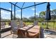 Covered lanai features comfortable seating and views of the lush landscape at 14369 Eagle Branch Dr, Nokomis, FL 34275