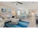 Open-concept living room leads to dining area with coastal decor and tiled flooring at 14369 Eagle Branch Dr, Nokomis, FL 34275