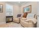 Cozy sitting room with recliner chairs, shuttered window, and charming decor at 14369 Eagle Branch Dr, Nokomis, FL 34275