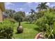 Lush backyard showcasing meticulously landscaped lawn and garden with a fire pit at 2773 Harvest Dr, Sarasota, FL 34240