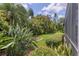 Secluded backyard featuring lush tropical landscaping providing enhanced privacy at 2773 Harvest Dr, Sarasota, FL 34240