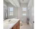 Cozy bathroom with white tiled shower and light wood vanity at 2773 Harvest Dr, Sarasota, FL 34240