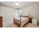 Comfortable bedroom with wood furnishings, plush carpet, and natural lighting from the window at 2773 Harvest Dr, Sarasota, FL 34240