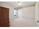 Bright bedroom features a ceiling fan, window, and closet, offering a cozy and functional space at 2773 Harvest Dr, Sarasota, FL 34240