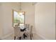 Cozy breakfast nook features a glass table and backyard views at 2773 Harvest Dr, Sarasota, FL 34240