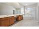 Bright bathroom featuring dual vanities, a soaking tub, walk-in shower, and natural light at 2773 Harvest Dr, Sarasota, FL 34240