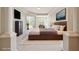 Spacious main bedroom featuring a king-sized bed, backyard access, and stylish decor at 2773 Harvest Dr, Sarasota, FL 34240