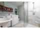 Modern bathroom with glass shower, sink, washing machine and a dryer at 2826 Marlette St, Sarasota, FL 34231
