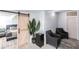 Cozy bedroom area with barn door entrance and gray seating area at 2826 Marlette St, Sarasota, FL 34231