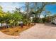 Paver driveway with lush landscaping and mature trees leads to the home's entrance at 2826 Marlette St, Sarasota, FL 34231