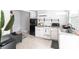 Well-lit kitchen with white cabinets, granite countertops, and retro-style refrigerator at 2826 Marlette St, Sarasota, FL 34231