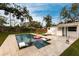 Backyard pool with sun loungers, a pink flamingo float, and surrounding greenery at 2826 Marlette St, Sarasota, FL 34231