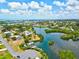 This aerial view shows the neighborhood's waterfront living with easy access to the bay and private boating docks at 424 Cezanne Dr, Osprey, FL 34229