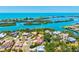An aerial view of waterfront homes showcases peaceful living near the bay, with lush greenery and docks at 424 Cezanne Dr, Osprey, FL 34229