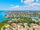 An aerial view of a waterfront community showcases picturesque blue skies, canals, and easy access to the bay at 424 Cezanne Dr, Osprey, FL 34229