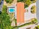 An aerial view of a well-maintained house featuring a screened-in pool and a meticulously landscaped circular driveway at 424 Cezanne Dr, Osprey, FL 34229