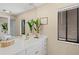 Bathroom with double vanity, ample counter space, and a large mirror at 424 Cezanne Dr, Osprey, FL 34229