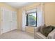 Comfortable bedroom featuring chair near bright window and a spacious closet at 424 Cezanne Dr, Osprey, FL 34229