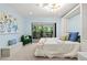 Cozy bedroom with large window showcasing natural greenery and built in cabinetry at 424 Cezanne Dr, Osprey, FL 34229