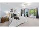 Light-filled bedroom features a desk by the window, plush carpet, and comfortable furnishings at 424 Cezanne Dr, Osprey, FL 34229