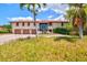 Beautiful two-story home with large windows, three-car garage, and lush landscaping at 424 Cezanne Dr, Osprey, FL 34229