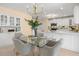 Well-lit kitchen with a dining table, showcasing modern appliances, white cabinetry, and stylish decor at 424 Cezanne Dr, Osprey, FL 34229
