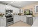 Bright kitchen features stainless steel appliances and ample cabinet space at 424 Cezanne Dr, Osprey, FL 34229
