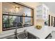 Kitchen featuring stainless steel sink, black framed window, and quartz countertops at 424 Cezanne Dr, Osprey, FL 34229