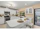 Modern kitchen with sleek white countertops, stainless steel appliances, and a breakfast bar for casual dining at 424 Cezanne Dr, Osprey, FL 34229