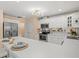 Modern kitchen features stainless steel appliances, white cabinets, and a breakfast bar for a sleek, functional design at 424 Cezanne Dr, Osprey, FL 34229
