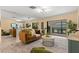 Bright living room with an open view into the kitchen and screened porch access at 424 Cezanne Dr, Osprey, FL 34229