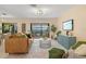 Open-concept living room with tan walls, modern decor, and screened porch access at 424 Cezanne Dr, Osprey, FL 34229