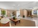 Cozy living room with natural light, wood paneling, and neutral decor at 424 Cezanne Dr, Osprey, FL 34229